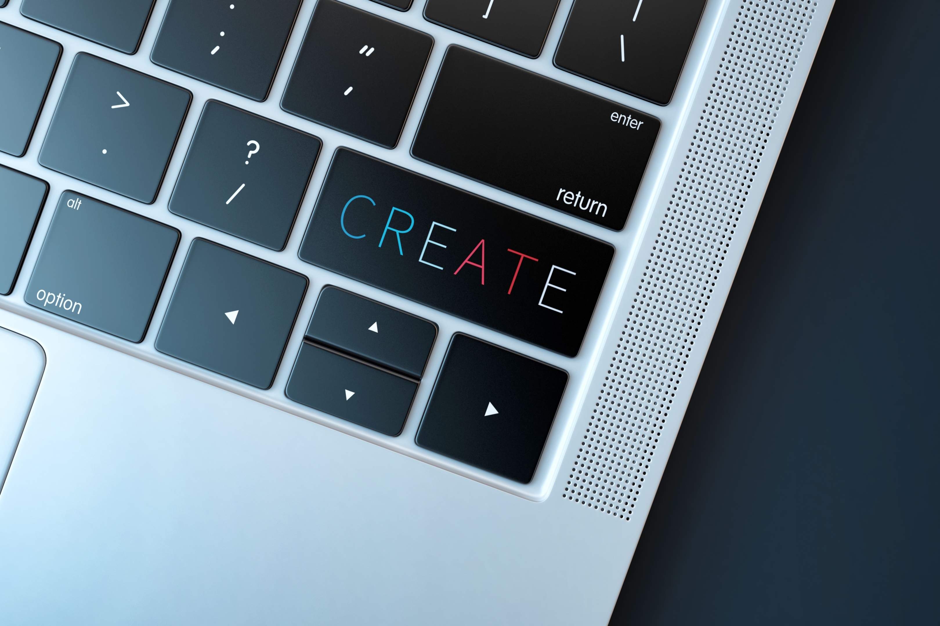 A close up image of the front right hand corner of a laptop keyboard with the word create on the shift key.